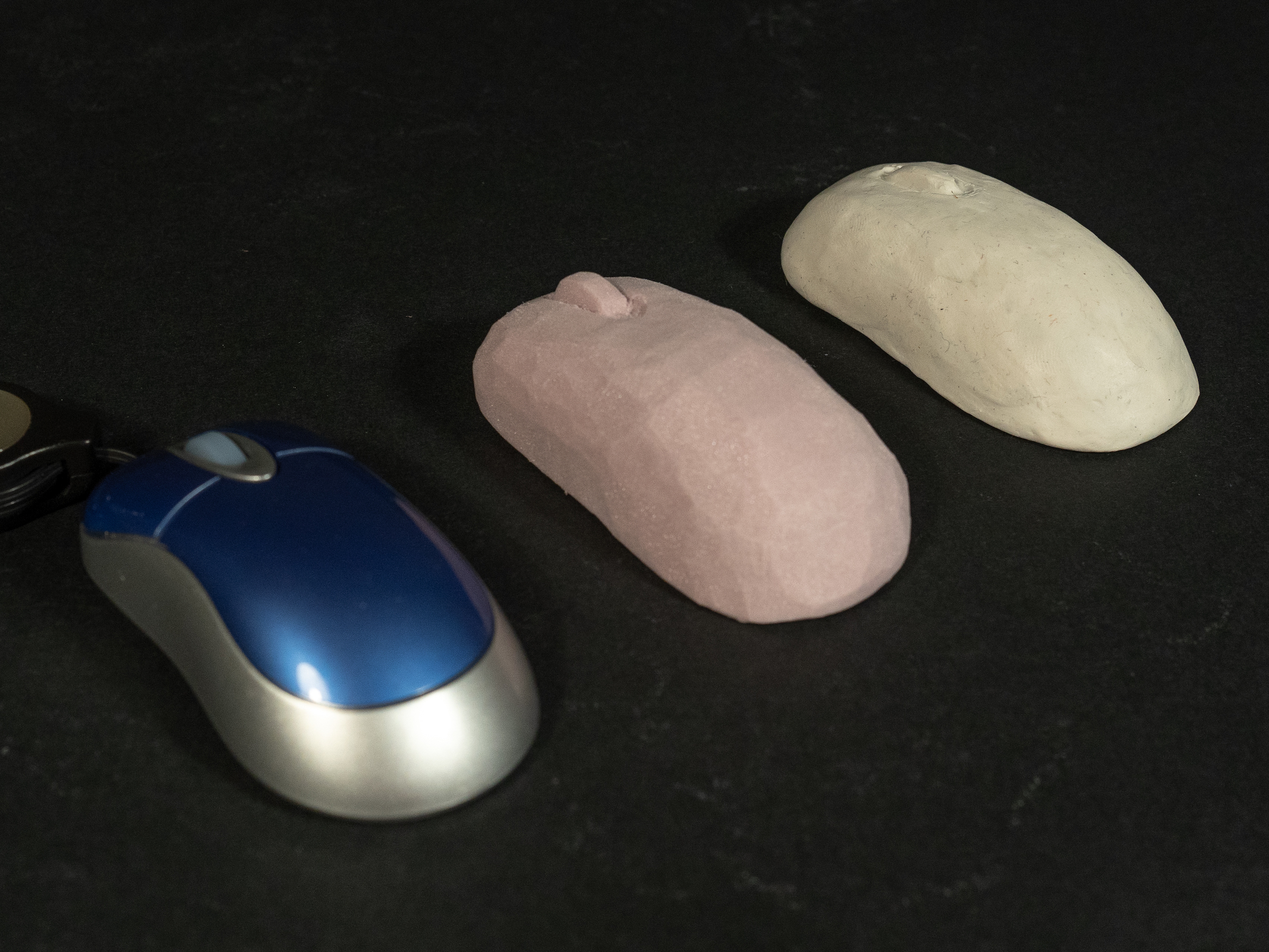 A computer mouse with one foam model and one clay model